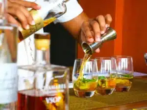 Bartender pouring drinks into glasses, illustrating the importance of understanding alcohol consumption limits before driving.
